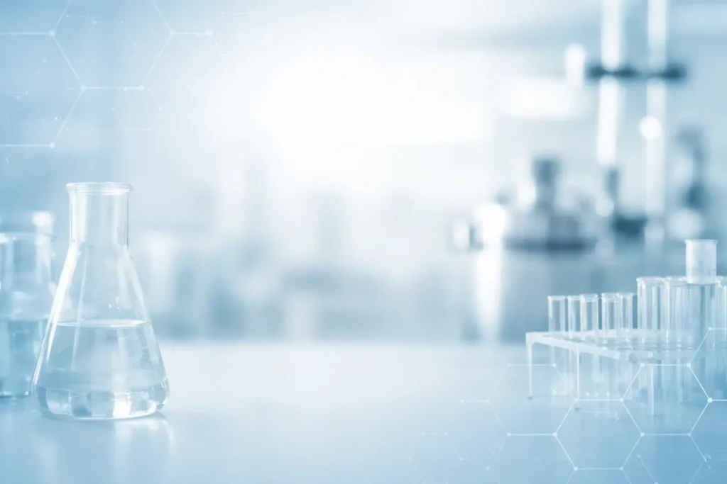 Glass flask and test tubes in a modern pharmaceutical laboratory setting